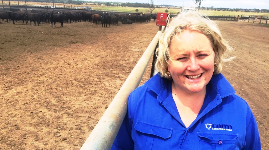 Amanda Moohen standing in cattle feedlot