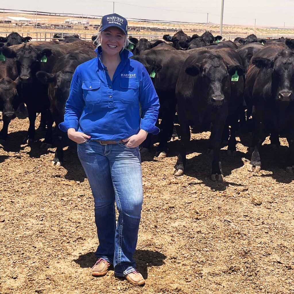 Amanda Moohen standing in pen with cows